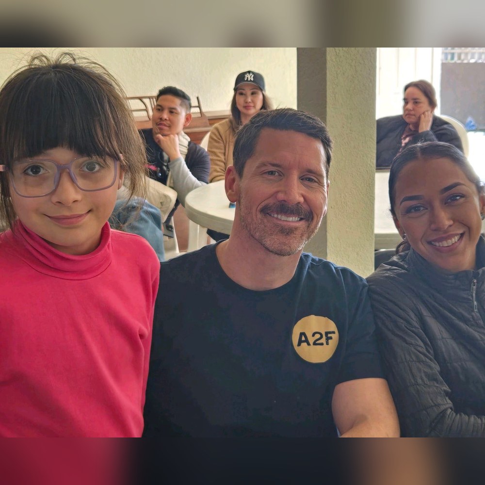 Adam Cato and his wife with a foster child during a volunteer visit to a shelter in Tijuana with Amigos 2 Familia